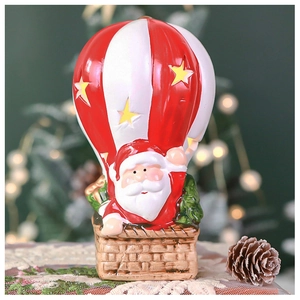 Detailed close-up of a festive Santa Claus in a red and white hot air balloon ornament