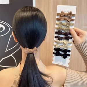 Set of 11 ribbed knit bow hair ties in earth tones like brown, beige and black