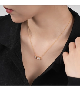 Close-up of 925 silver gold-plated necklace with sparkling rectangular zircon pendant