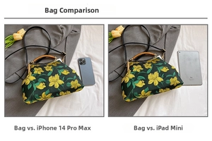 Detail shot showing green floral embroidery handbag size compared to a smartphone