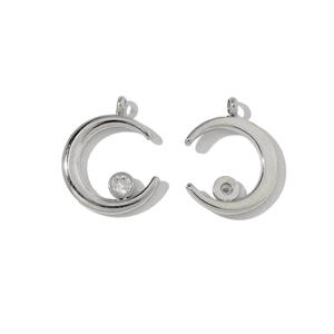 Close-up of crescent moon charms in silver finish with crystal inlay for DIY jewelry making