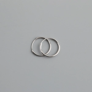 Detailed view of polished S925 sterling silver hoop earrings with endless closure mechanism