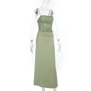 Close-up detail of green lace patchwork and slim fit design on a long dress