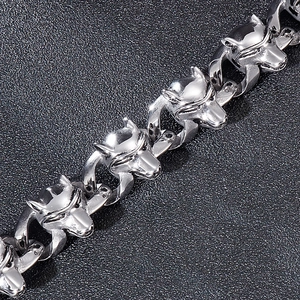 Macro detail of gothic silver wolf head clasp on a punk style stainless steel bracelet