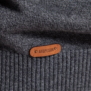 Men's dark grey knit sweater with detailed texture and classic leather brand logo tag