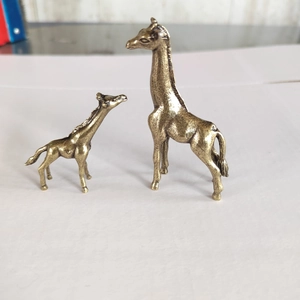 Detailed view of two bronze giraffe figurines with intricate metal muscle texture and finish