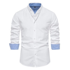 Detail view of white slim fit shirt with blue contrast trim on collar and cuffs