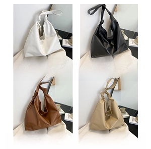 Detail of minimalist leather tote bags in four colors with stylish knotted handles