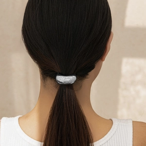 Detail of silver metallic hair cuff ponytail holder with a minimalist geometric finish