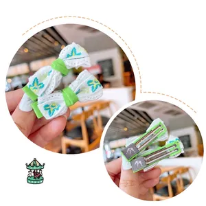 Embroidered floral bow hair clip set with green and yellow petals on white lace base