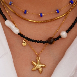 Layered gold necklace set with starfish shell pendants and natural pearl beads