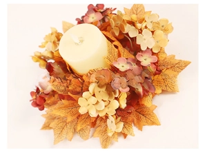 Macro view of autumn candle holder with maple leaves and hydrangea for Thanksgiving decor