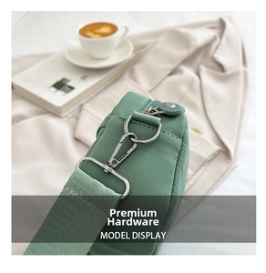 Close-up of detachable mint green shoulder strap with premium silver metal hardware