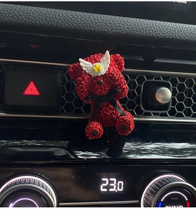Detailed view of a red bear car air vent clip diffuser with roses and white wings