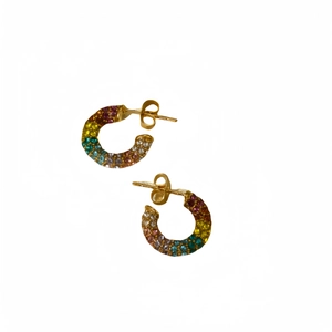 Luxurious C-shaped gold earrings with colorful rhinestones and pearls on white background