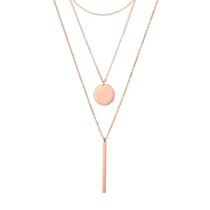 Macro view of triple-layered rose gold chain necklace with geometric circle and bar pendants