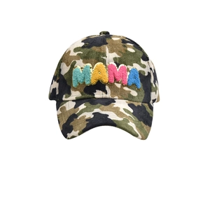 Detail of colorful MAMA towel embroidery on a camouflage corduroy baseball cap