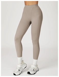 Side view detail of high-waisted taupe yoga leggings with structural stitching lines