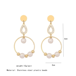 Detail of gold drop earrings with rhinestones and pearls showing 6cm height measurement