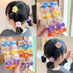 Detail of candy-colored flower hair ties and bow headbands for children hair styling