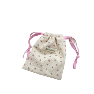 Floral corduroy drawstring pouch for cosmetics and small travel essentials storage