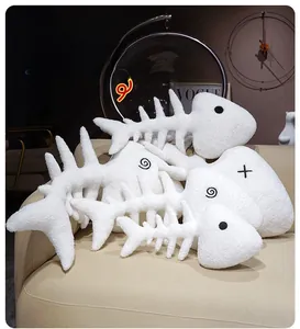 Detailed view of white plush fishbone pillows with soft curly fleece texture and embroidery