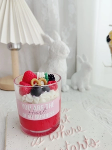 Detail of strawberry dessert scented candle with cream wax and pretzel topping