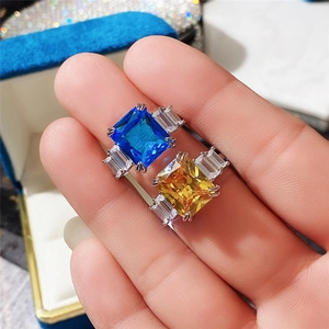 Luxe silver rings with square-cut blue and yellow crystals and side baguette stones