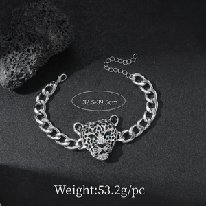 Macro shot of silver leopard bracelet with green eyes on dark stone, 32.5-39.5cm length
