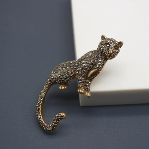 Vintage leopard brooch in antique gold finish with dark grey rhinestones and pearls