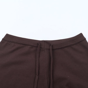 Detail showing elastic waistband with drawstring on brown knitted casual pants