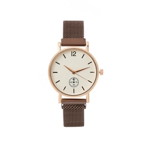 Detail of rose gold watch case with mesh strap and minimalist beige textured dial