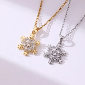 Macro shot of gold and silver snowflake pendants with sparkling zircon stone settings