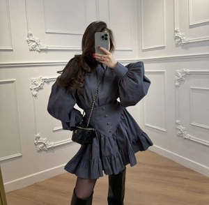 Detailed view of puff sleeves and ruffled hem on dark blue French vintage dress