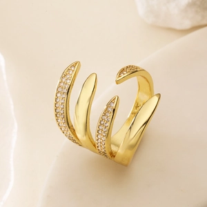 Minimalist 18K gold plated copper ring with geometric zircon claw design on stone surface