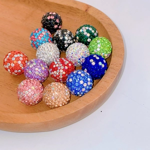 Colorful rhinestone clay beads for DIY jewelry making displayed in a wooden tray