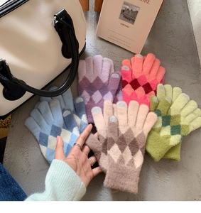 Macro detail of multicolored argyle pattern knitted warm gloves in a five-pair set