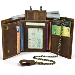 Macro view of bifold brown leather wallet showing card slots and money compartment