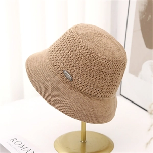 Khaki knitted cloche hat for women with elegant crochet texture on a display stand