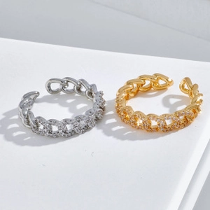 Detail of gold and silver cuban chain rings with micro-pave cubic zirconia stones