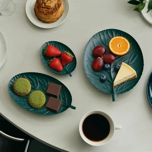 Set of three vintage leaf-shaped iron trays in forest green for home decor and snacks