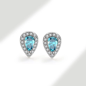 Macro view of pear-shaped blue gemstone earrings with halo diamonds in s925 silver