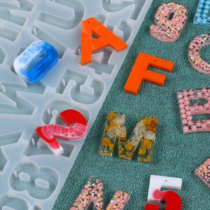 Macro detail of alphabet silicone mold with colorful resin letters and glitter numbers
