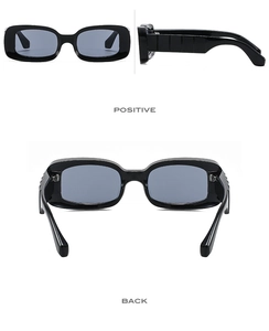 Detail of black rectangular sunglasses with wide 3D textured temples and dark lenses