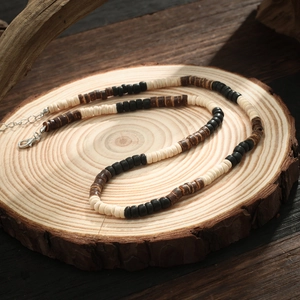 Bohemian men's necklace with black, white, and brown coconut shell wood beads and metal clasp