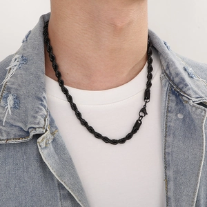 Close-up of a black stainless steel twist rope chain necklace worn by a male model