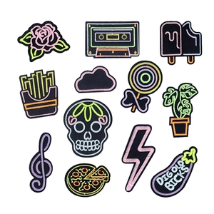 Neon glow embroidery patches set featuring pizza skull and tape designs on white background
