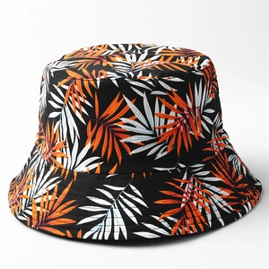 Detail of tropical palm leaf print on a black cotton bucket hat with premium stitching