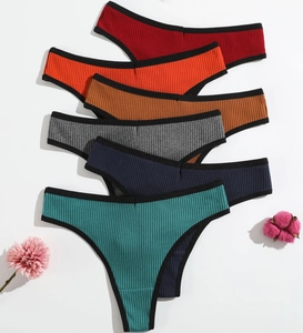 Flat lay of 6-pack ribbed cotton thongs in various colors with black trim accents