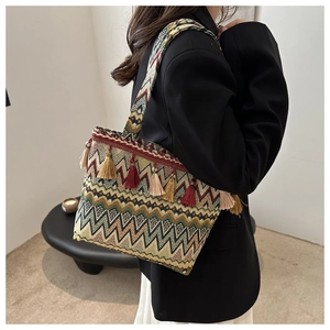 Detail shot of colorful ethnic woven tote bag with fringe tassels and zigzag patterns